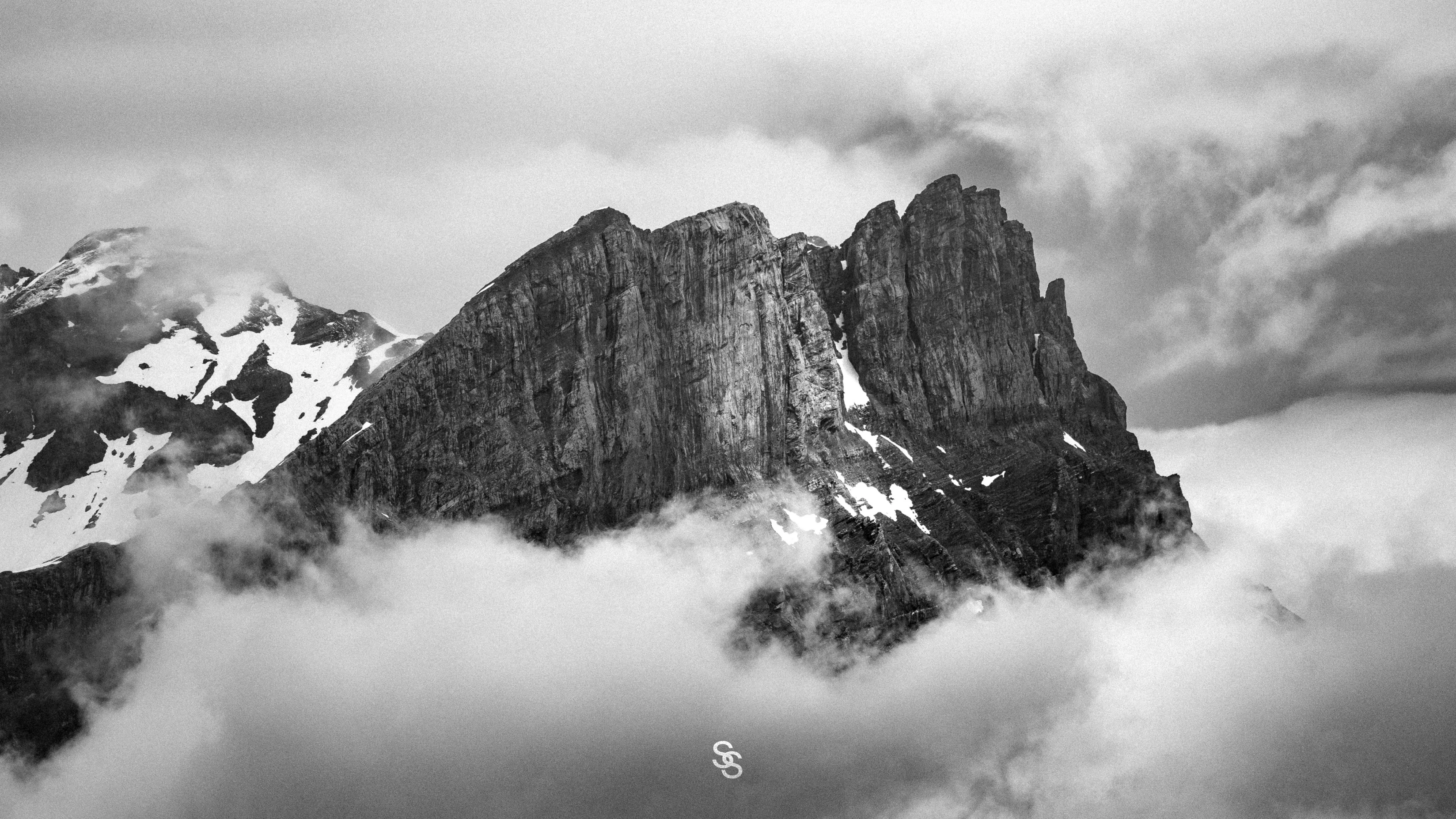 Snow-covered mountain above the clouds with the Ski Supply mark