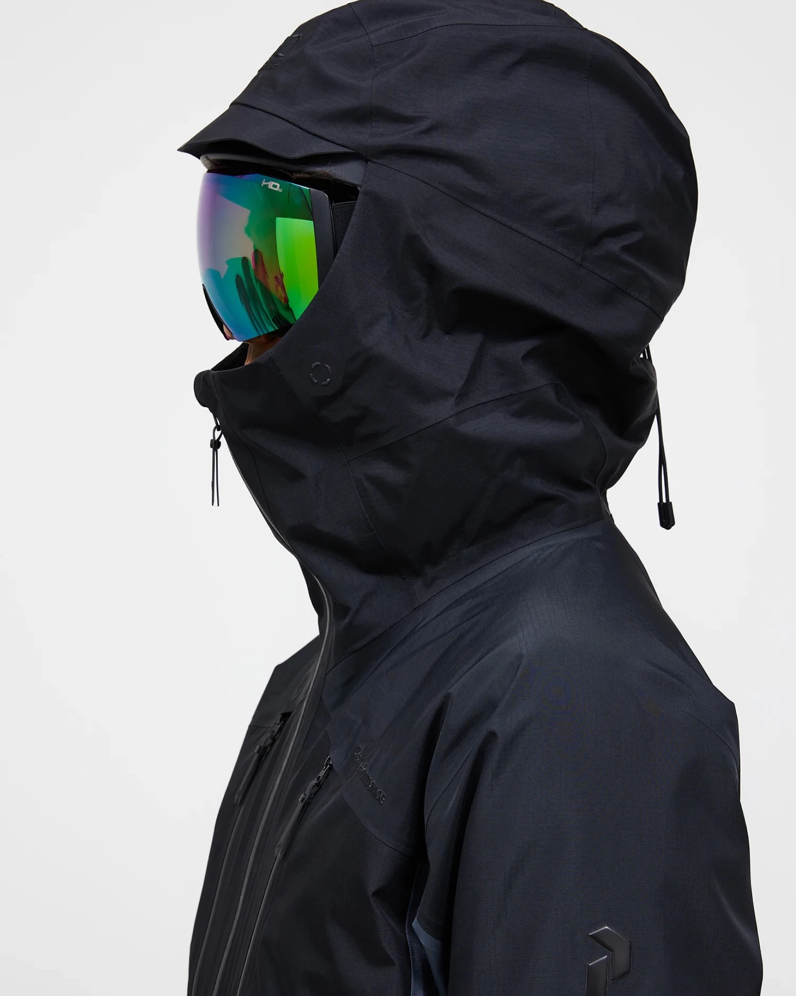 Close view of a dark hooded shell jacket with goggles