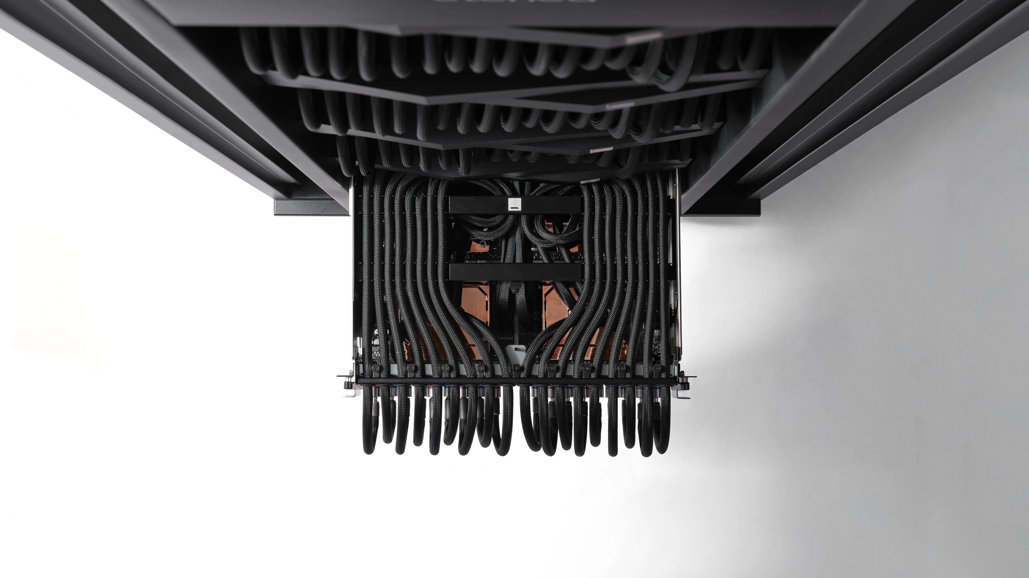 Etched rack hardware viewed from below, framed by braided cabling