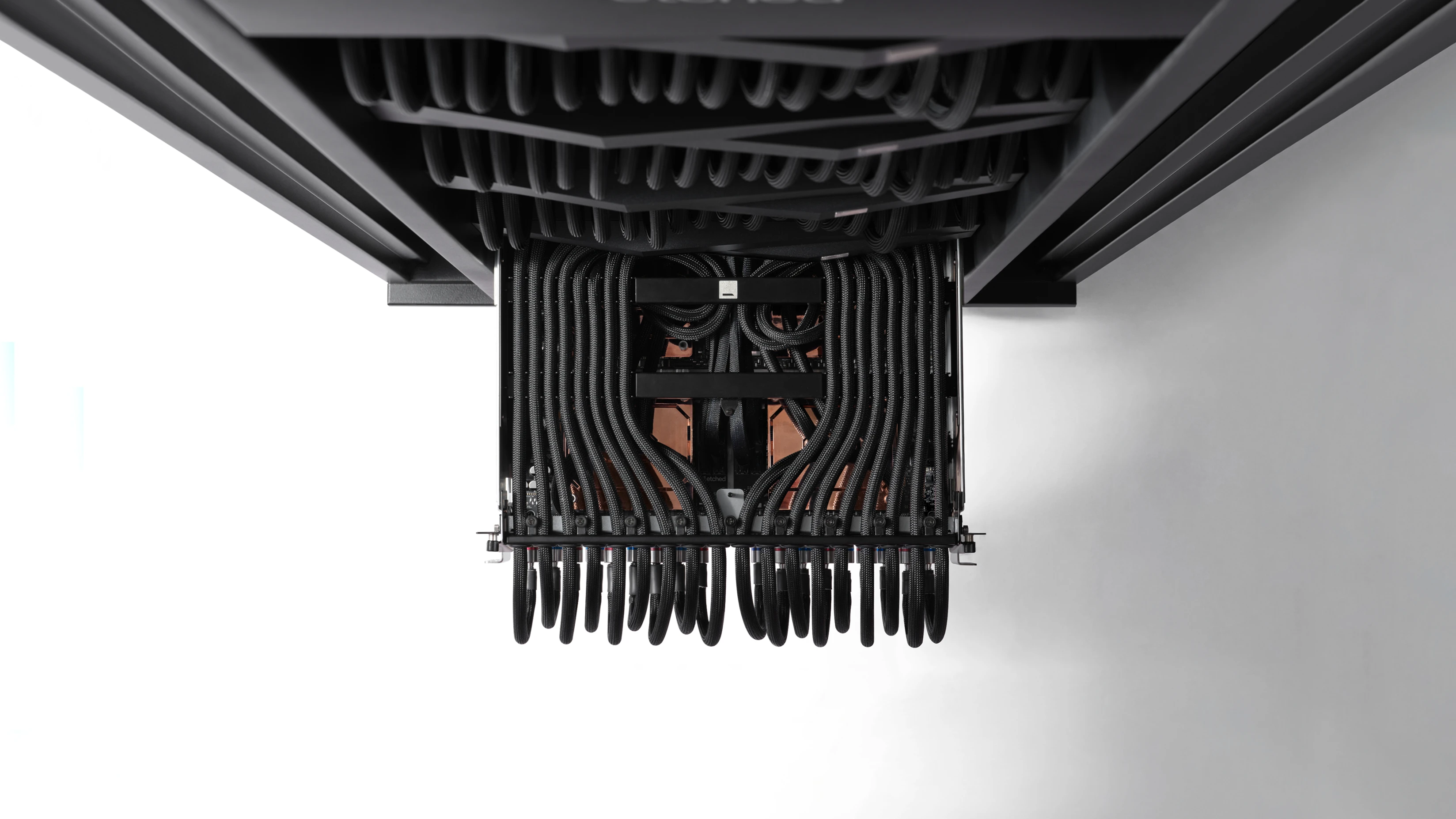 Etched rack hardware viewed from below, framed by braided cabling
